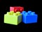 Plastic multicoloured blocks of the constructor on the black background