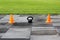 Plastic orange signal cones stand at the stadium in preparation for the competition for lifting weights.