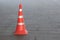 Plastic orange traffic cone on city street