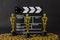 Plastic Oscar awards, a clapboard and golden stars confetti