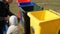 Plastic, paper, metal, glass waste sorting bins. The father teaches the child to sort the garbage