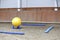 Plastic physioball on the sand during training for beginner riders and horses at riding school indoors