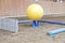 Plastic physioball on the sand during training for beginner riders and horses at riding school indoors