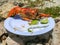 A plastic plate with a huge lobster in open air with beautiful sunlight