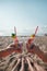 Plastic pollution in ocean environmental problem, girls hands holding plastic cups with straws and cocktail from beach garbage -