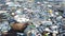 Plastic pollution trash in ocean with different kinds of garbage - plastic bottles, bags, wastes floating in water