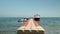 Plastic pontoon in sea with moored yacht and jet bikes. Empty floating platform pontoon on water. Sun reflected in clear sea water