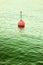 Plastic red bouy on a calm lake - toned image with copy space