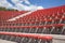 Plastic red seats on football stadium or amphitheater