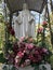 Plastic roses adorn the Most Blessed Virgin Mary in a Catholic Courtyard in Otwock, Poland