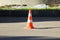 plastic signaling traffic cone encloses a place in the parking lot for trucks
