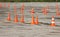 plastic signaling traffic cones are standing on the site where the drivers pass the exam the right trucks driving.