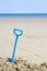 Plastic spade on sandy beach