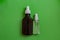 Plastic spray bottles for antiseptic medical packaging on green background