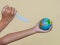 Plastic steak knife is destroying the globe, which is concept of global environment from plastic