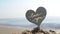 Plastic stick shape of heart with words Love you sand beach sea shore background