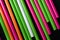 Plastic straws different colors on a dark background