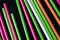 Plastic straws different colors on a dark background