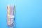 Plastic straws in package on blue background