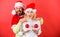 Plastic surgery. Man santa hat hold balls christmas ornament in front of female breasts. Christmas balls symbol implant