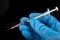 Plastic syringe and needle in hand in medical glove. Medical accessories in the hospital