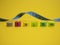 Plastic tags of clothing sizes for the store. Isolated on a yellow background