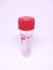 Plastic test tube with red stopper for collecting samples in the laboratory