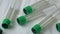 Plastic test tubes with green caps for the collection of samples. Medical modern medicine