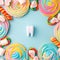 Plastic tooth in many colorfull rainbow sweetness from sugar. Caries and sugar concept. Dental care concept on blue background