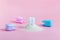 Plastic tooth and toothbrush in big pile of sugar. Caries and sugar concept. Dental care concept on pink background. Cleaning