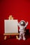 Plastic toy astronaut with paper note template mock up for your text on colorful red background Copy space. Concept of