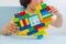 Plastic toy blocks, designer of children`s toys. Bright building blocks in the shape of a heart in children`s hands