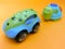 Plastic toy blue car, turtle, fast car overtakes, on orange background