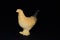 Plastic toy chickens on a black background. Realistic toy Copy Space