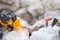 Plastic toy in construction. Drilling large boulders at construction site