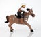 Plastic toy cowboy on galloping horse