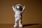 Plastic toy figure astronaut on beige neutral background Copy space. Concept of out of earth travel, private spaceman