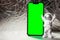 Plastic toy figure astronaut with mobile phone chroma key green screen for your advertisement Copy space. Concept of out