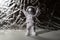 Plastic toy figure astronaut on silver background Copy space. Concept of out of earth travel, private spaceman