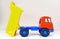Plastic toy tipper dumper truck, on white global altered