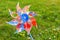 Plastic toy windmill  turbine on green blurred grass background