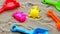 Plastic toys, Colorful shovels on sand.