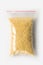 Plastic transparent zipper bag with full raw millet groats isolated on white, Vacuum package mockup with red clip. Concept