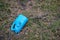 Plastic trash in the forest. Tucked nature. Plastic container lying in the grass.