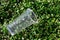 Plastic tumbler waste on leaves green, garbage waste drinking glass plastic