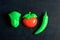 Plastic vegetable collection set of tomato, chili and lettuce on isolated dark background