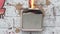 The plastic wall light switch on the wall lights up and melts. There was a short circuit and a fire started, close-up,