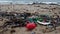 Plastic washed up on the beach. Low angle closeup. Shallow depth of field, slow motion.