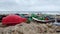 Plastic washed up on the beach. Low angle closeup. Shallow depth of field, slow motion.