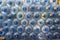 Plastic water bottle background, blue bottle caps, orderly arrangement. Empty bottles for drinking water. Heap of empty plastic dr